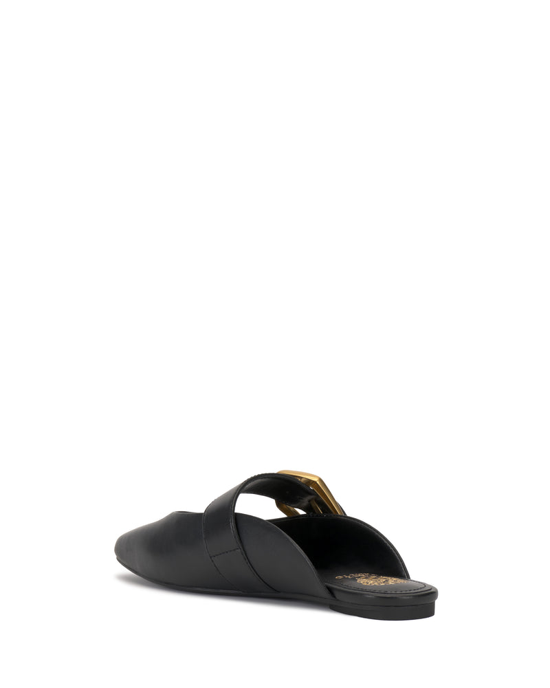 The Vince Camuto Vellma Buckle Mule is a black, backless slip-on with a closed pointed toe and a gold buckle on its upper strap, displayed from the rear against a white background.