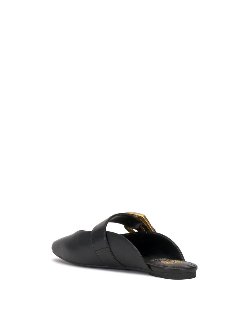The Vince Camuto Vellma Buckle Mule is a black leather slip-on flat with a pointed toe, a stylish top strap accented by a gold-tone buckle, and a comfortable flat sole, shown from the back angle.
