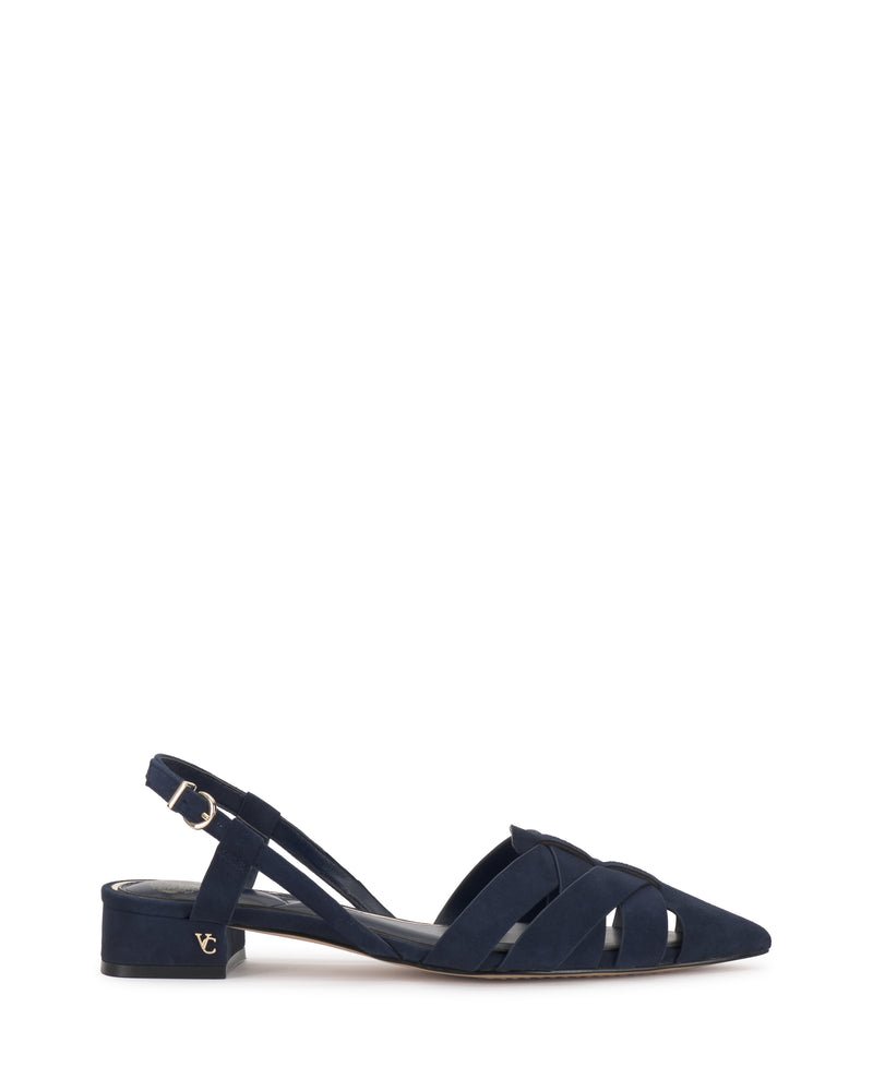 The Vinesha Sandal by Vince Camuto is a navy blue suede slingback with a low block heel, pointed toe, crisscross front straps, metallic logo near the heel, and an adjustable ankle strap.
