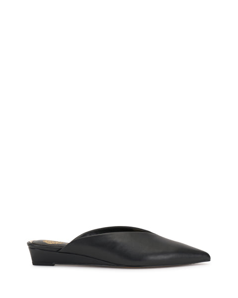 The Vinia Mule by Vince Camuto is a black, pointed-toe shoe with a low wedge heel and sleek, minimalist design, displayed against a plain white background.