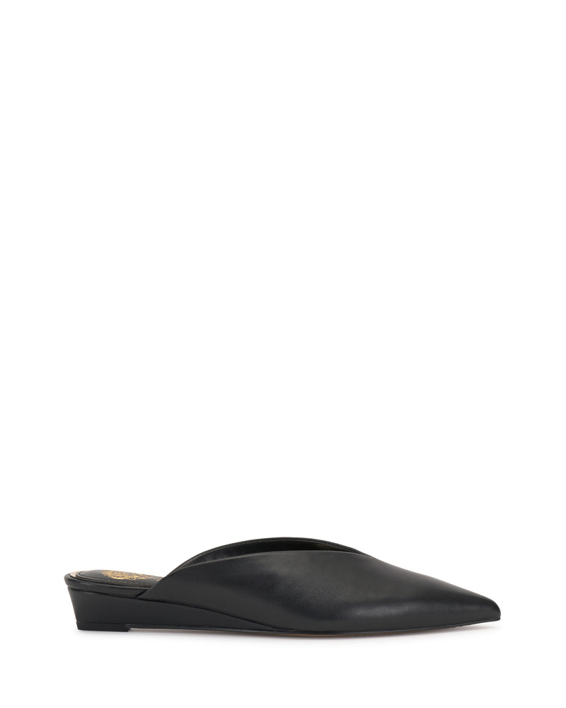 The Vinia Mule by Vince Camuto is a black, pointed-toe shoe with a low wedge heel and sleek, minimalist design, displayed against a plain white background.