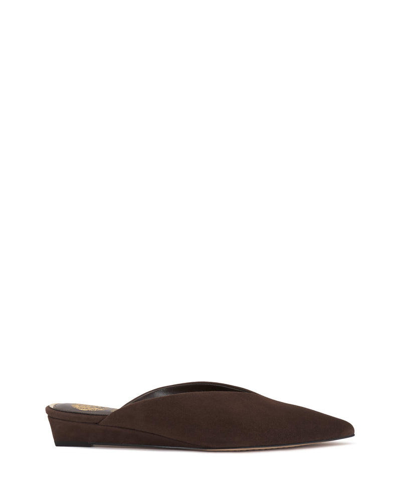 The Vinia Mule by Vince Camuto is a single brown suede slip-on shoe featuring a low heel and pointed toe, captured against a white background.