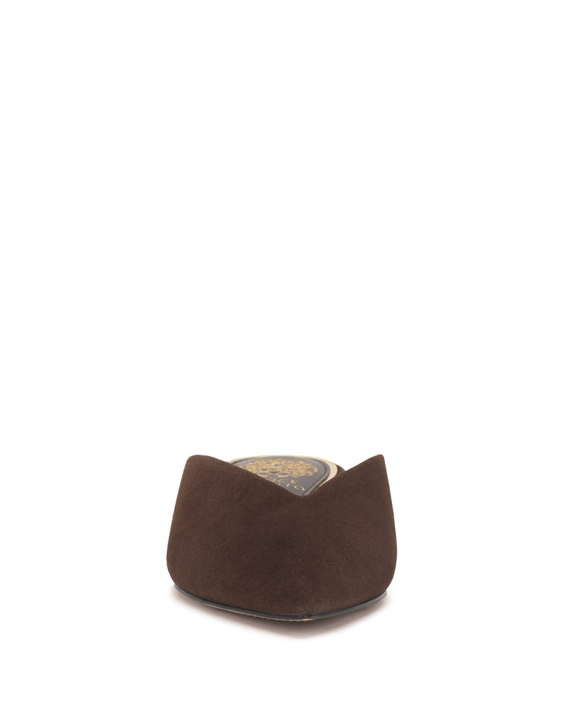 A front view of the Vinia Mule by Vince Camuto in brown suede, featuring a gold emblem on the insole, set against a white background.