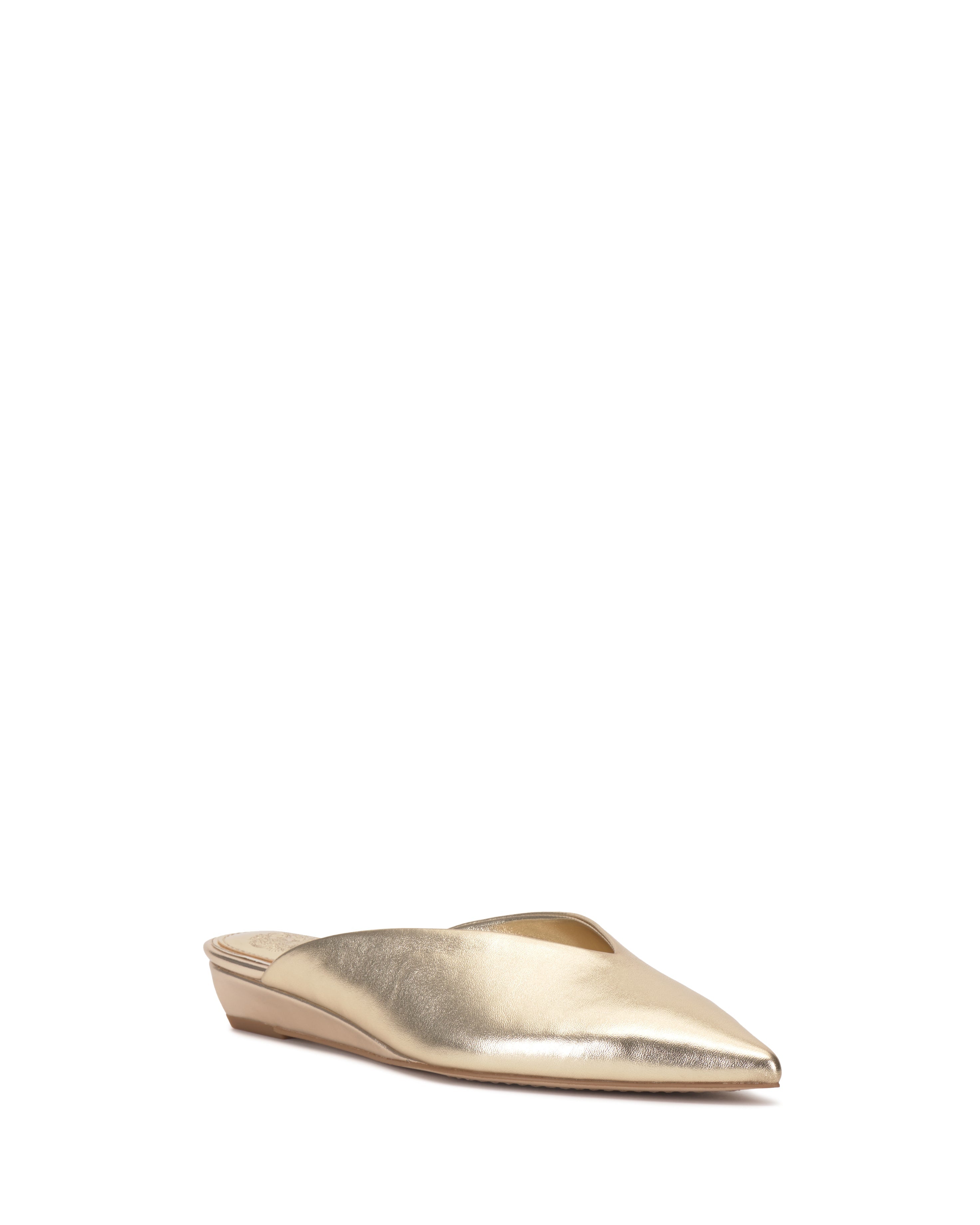 The Vinia Mule by Vince Camuto is a single gold, pointed-toe shoe with a low wedge heel and backless design, displayed against a white background.