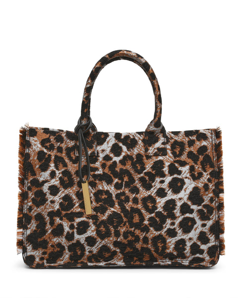 Introducing the Zhury Tote Bag by Vince Camuto—a rectangular handbag with two handles, adorned in a striking brown and black leopard print. This fashionable tote features chic frayed edges and a gold rectangular tag on one handle, making it a standout accessory for any outfit.