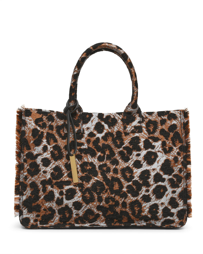 Introducing the Zhury Tote Bag by Vince Camuto—a rectangular handbag with two handles, adorned in a striking brown and black leopard print. This fashionable tote features chic frayed edges and a gold rectangular tag on one handle, making it a standout accessory for any outfit.