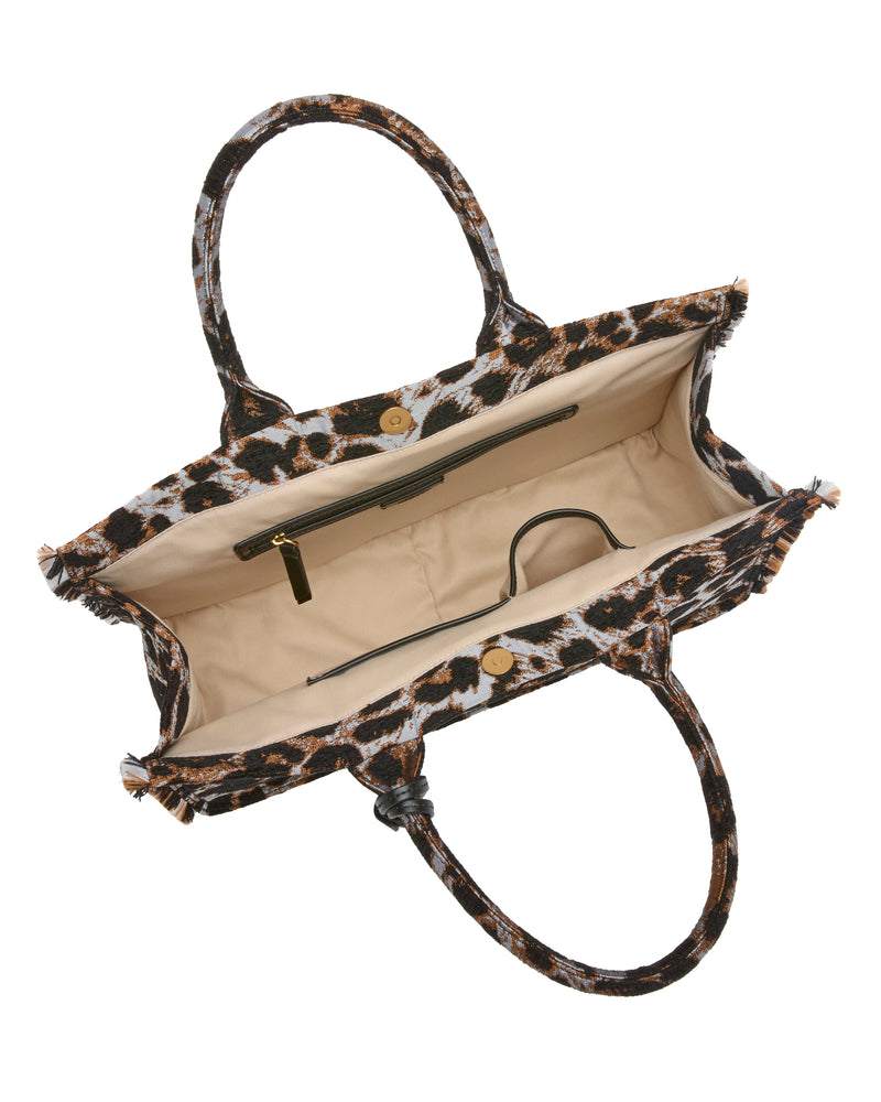 Here’s a rewritten version using your product data: Open top view of the Vince Camuto Zhury Tote Bag, featuring dual handles, a roomy beige interior with a zip pocket, and secured by a magnetic closure.