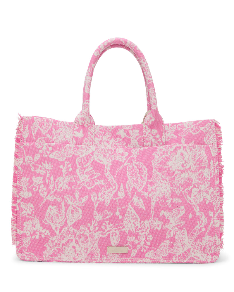 The Vince Camuto Zhury Tote Bag is pink with white floral patterns, two handles, and subtle fringe along the edges.