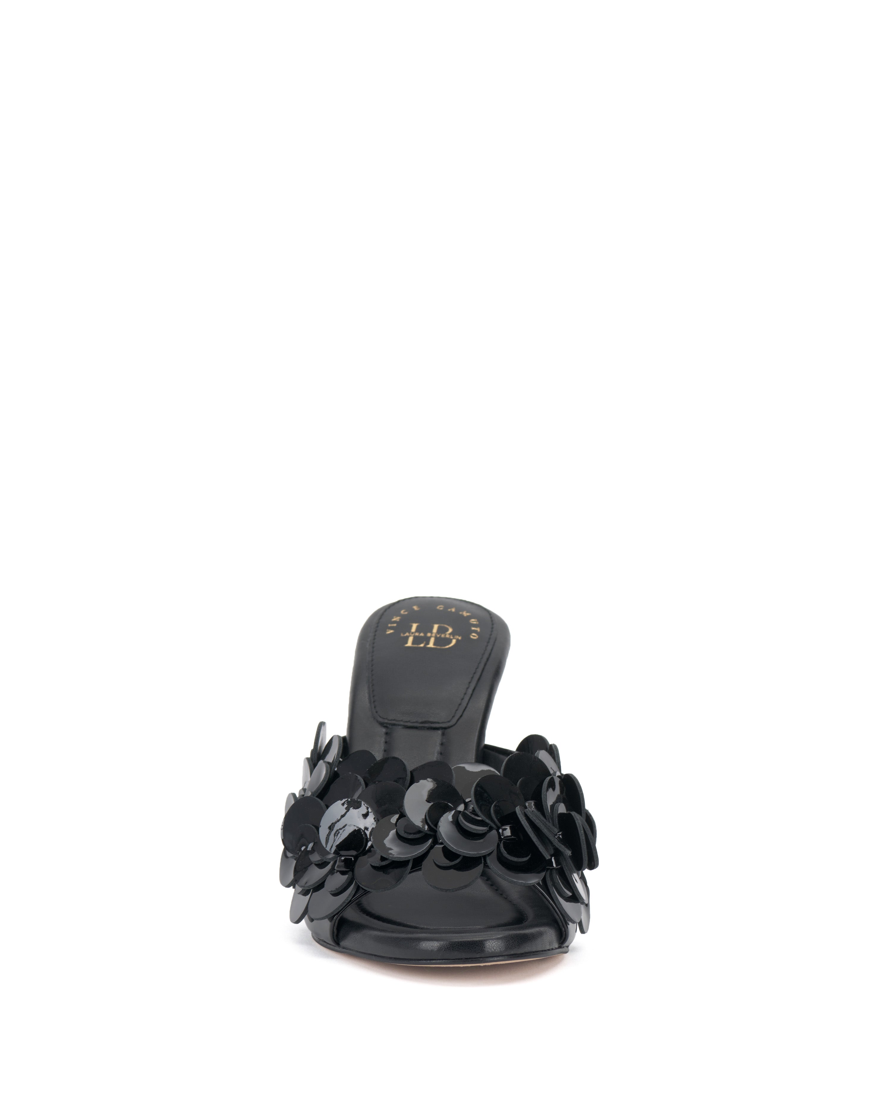Front view of the Vince Camuto Rose Mule, a black open-toe slide featuring 3D blossom accents on the upper, low heel, cushioned footbed, and gold Vince Camuto logo on the insole.
