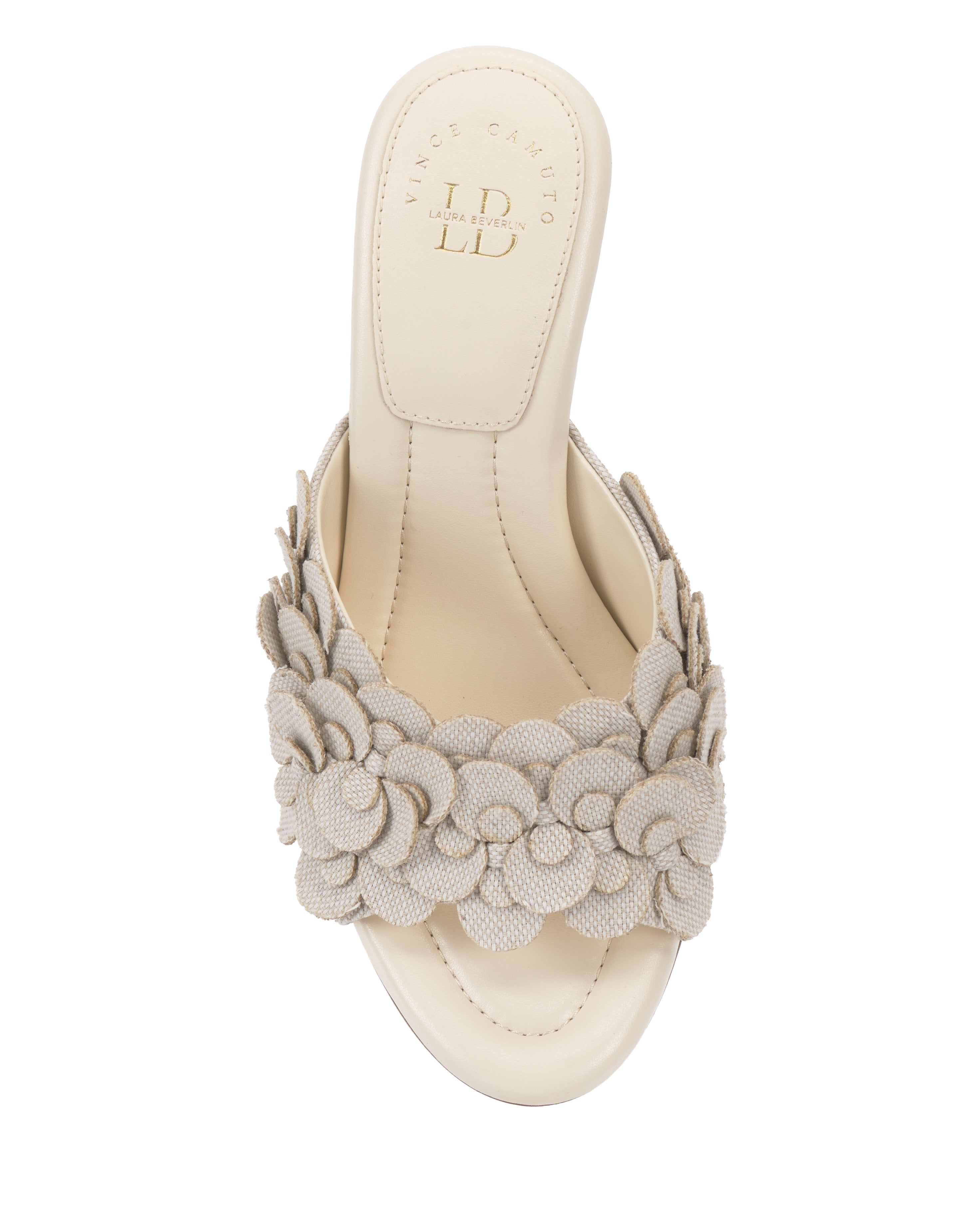 A top view of the Rose Mule by Vince Camuto, a beige open-toe mule with a thick strap adorned with textured fabric flowers and a padded footbed for comfort.