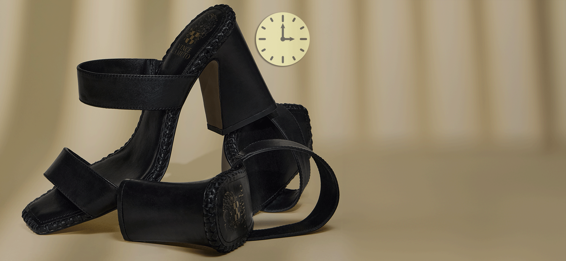 black high heeled shoes on tan background