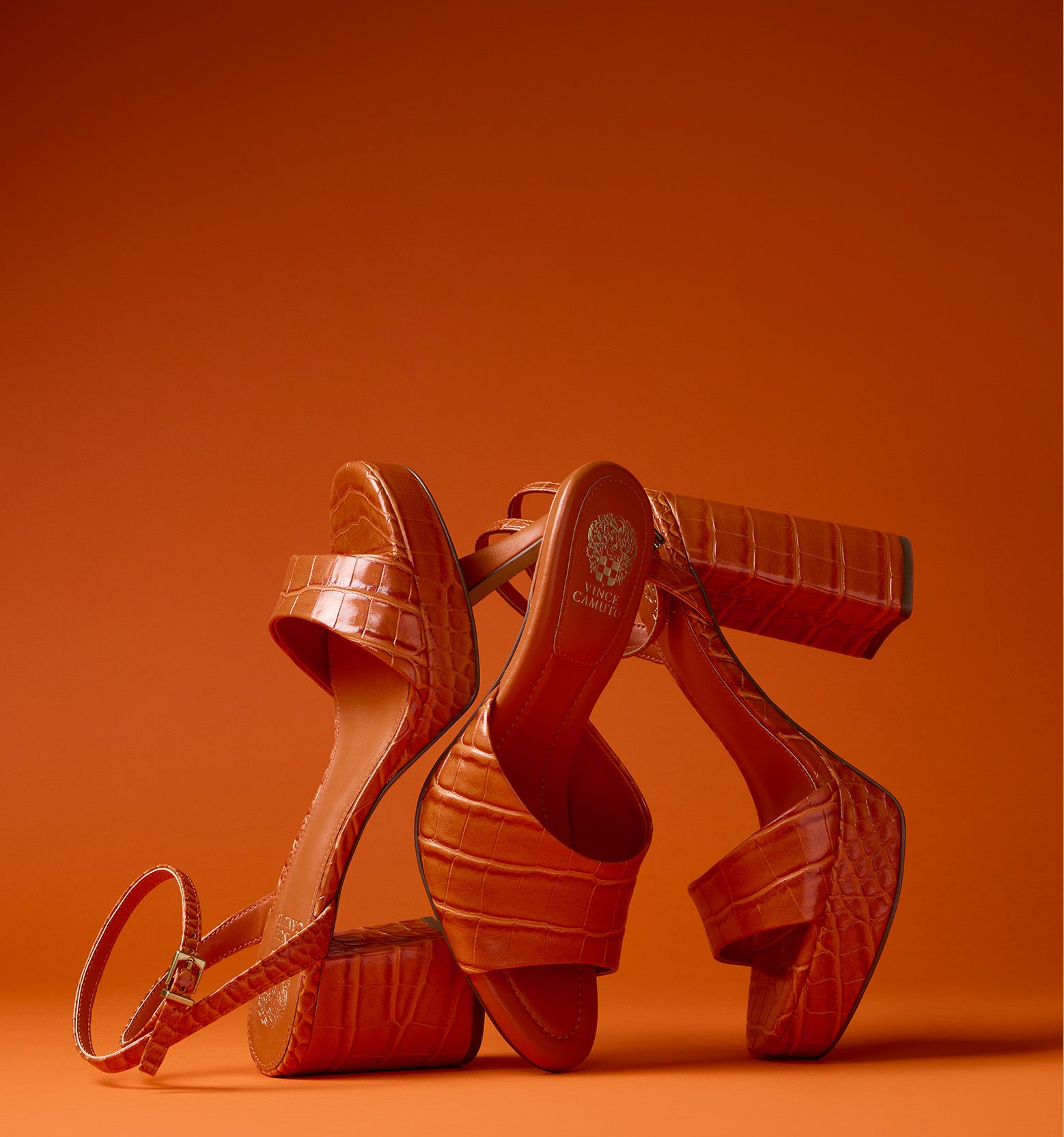three orange textured heels on an orange background