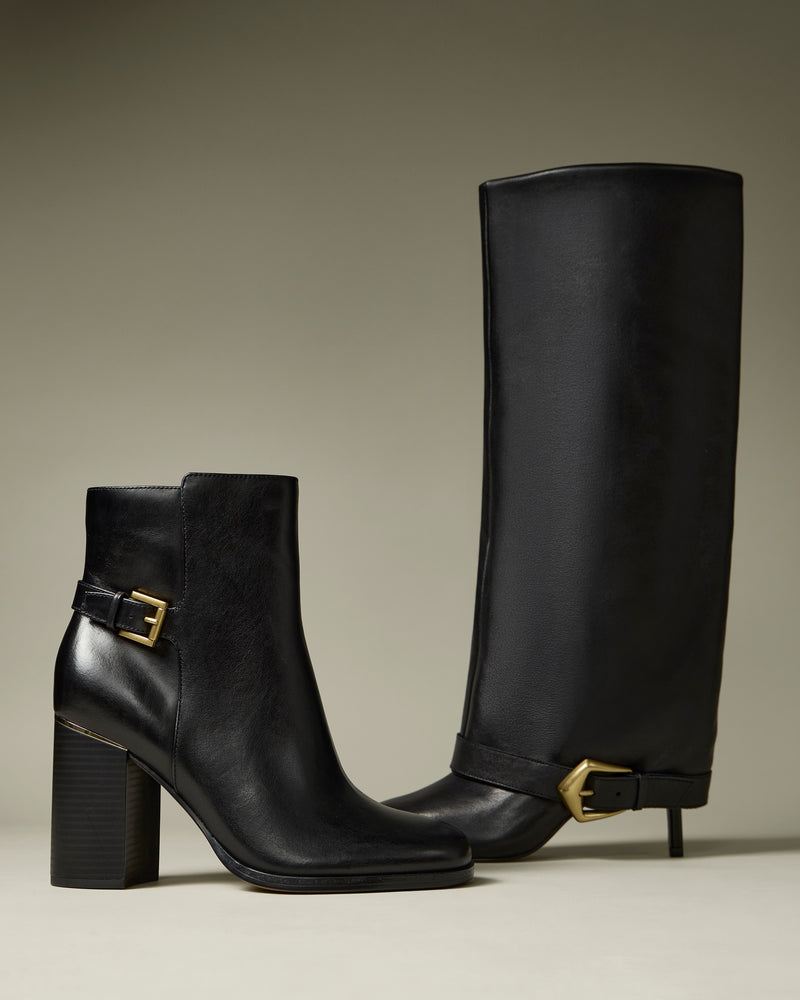 Two black leather boots by Vince Camuto are displayed upright on a neutral background. The Margee Wide Calf Cuff Knee High Boot features a chunky heel and gold buckle, while the other is an ankle-length boot with similar detailing.