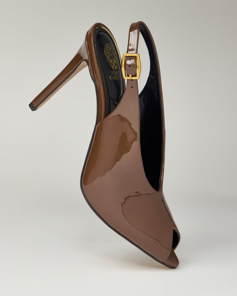 The Helenza Pump by Vince Camuto is a brown patent leather slingback featuring a peep toe, gold buckle strap, and skinny heel, displayed upright against a plain light background.