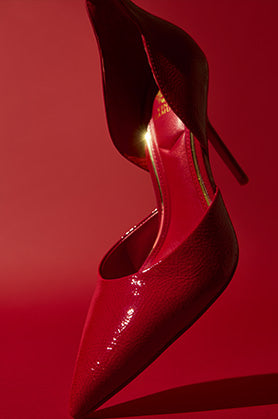 red pump shoe on red background
