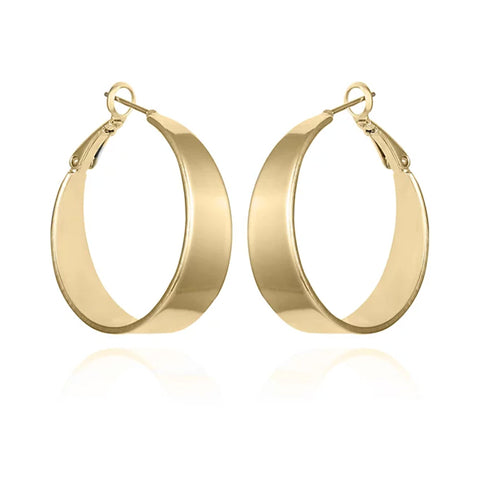 The Vince Camuto Band Thick Hoop Earrings feature classic gold-tone, wide smooth bands with latch-back clasps, shown against a white background.