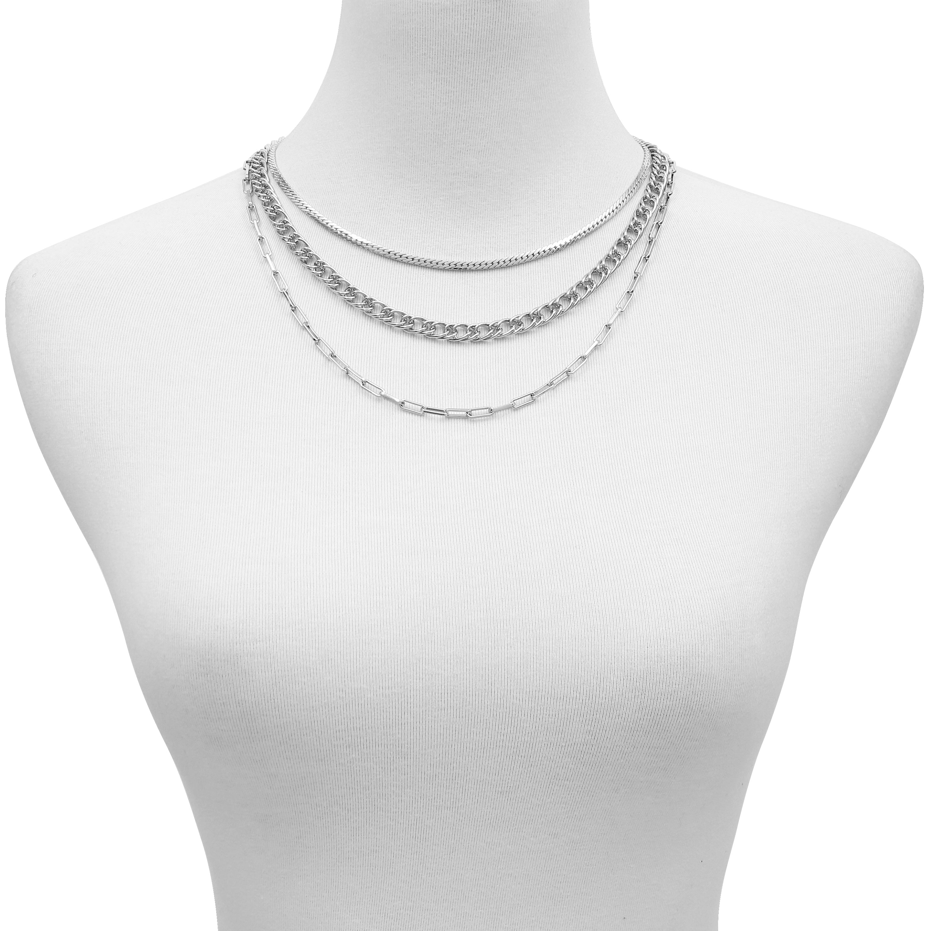 A display bust features the Vince Camuto Multi Layered Chain Necklace, designed with three silver chains: a thin chain, a medium flat chain, and a longer oval link chain.