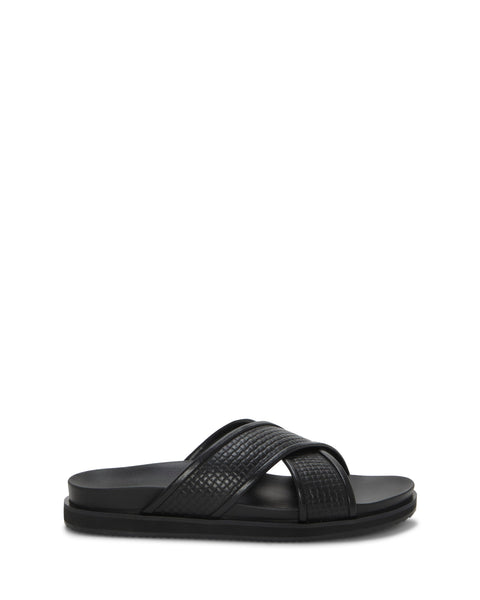 The Vince Camuto Men's Dabor Cross-Band Sandal, shown in profile against a white background, features two wide black textured straps in a classic cross-band design with a flat sole.