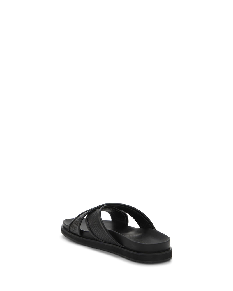 The Vince Camuto Men's Dabor Cross-Band Sandal features black crisscross straps and an open toe, shown from the back at an angle on a plain white background.