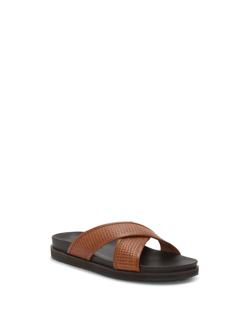 The Vince Camuto Men's Dabor Cross-Band Sandal features two wide, crisscrossed textured straps and a black EVA cushioned sole, shown on a plain white background.