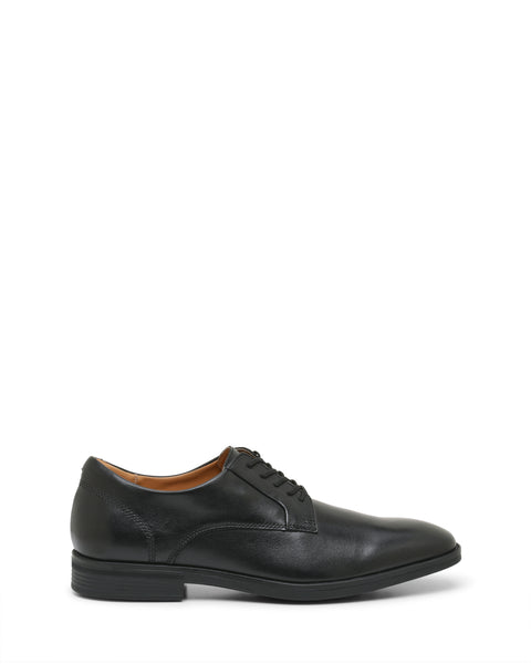 The Vince Camuto Men’s Draymand Oxford is a black leather dress shoe with laces, featuring a low heel and a slightly rounded toe, shown from the side on a white background.