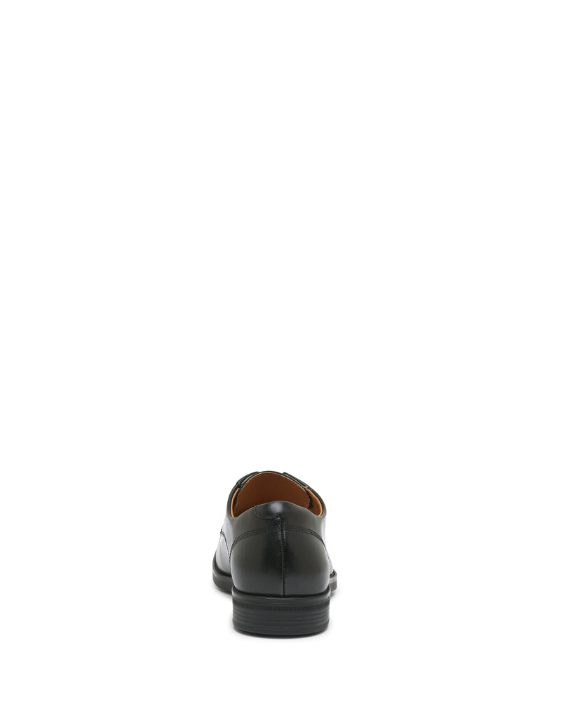 A single Vince Camuto Men’s Draymand Oxford dress shoe is displayed from the back on a white background, highlighting the heel and rear stitching details.