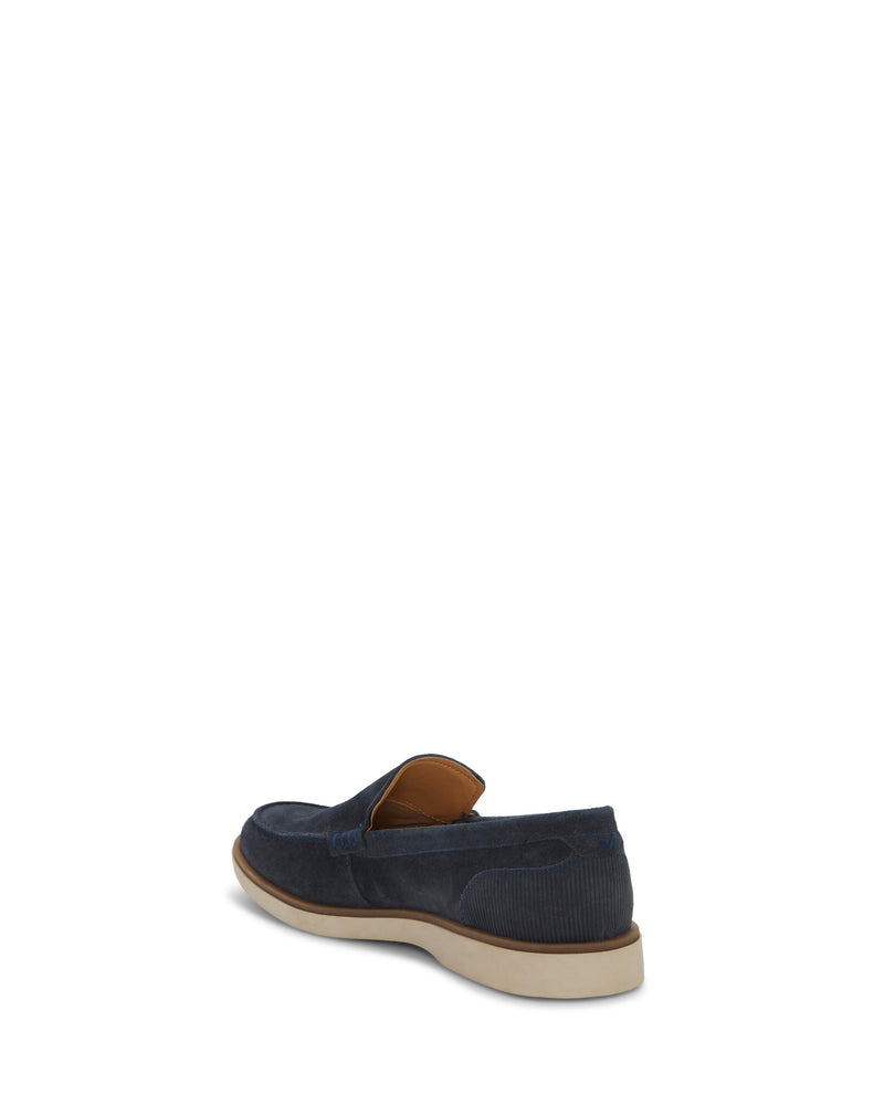 The Vince Camuto Men's Sevrin Casual Loafer features navy blue suede, a white sole, and a comfy EVA insole, shown from the back and side on a plain white background.