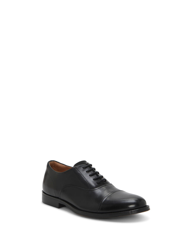 The Vince Camuto Men's Urii Dress Oxford is a single black leather shoe featuring a rounded toe and lace-up front, displayed against a plain white background.