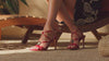 woman modeling bags and shoes on tan background